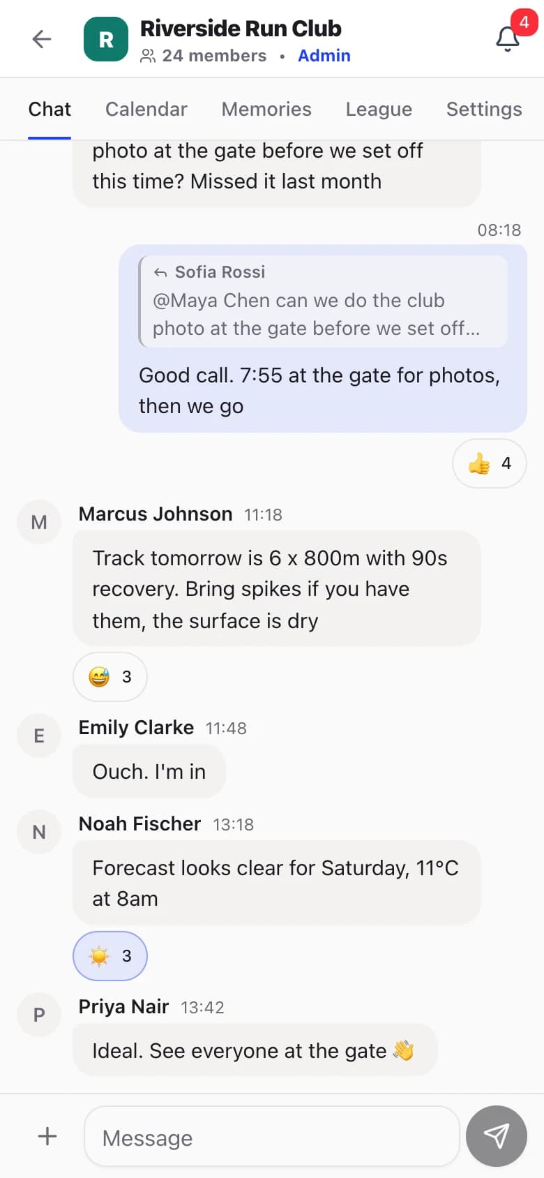 Riverside Run Club chat on a phone: a quoted reply about the club photo at the gate, track session details for tomorrow and emoji reactions